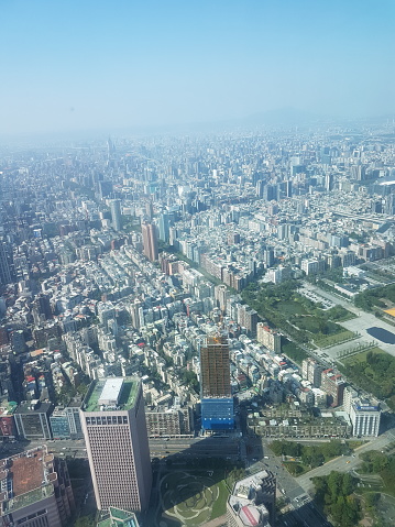 Taipei city seen from Taipei 101 tower, with TWTC International Trade Building (in front, left side) and Zongshan Park and National Dr. Sun Yat-Sen Memorial Hall (in the middle, right side) along ren'ai road.