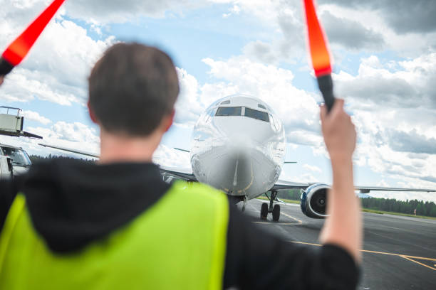 istock Aircraft Obeying Airport Ground Crew Instructions 1927313477