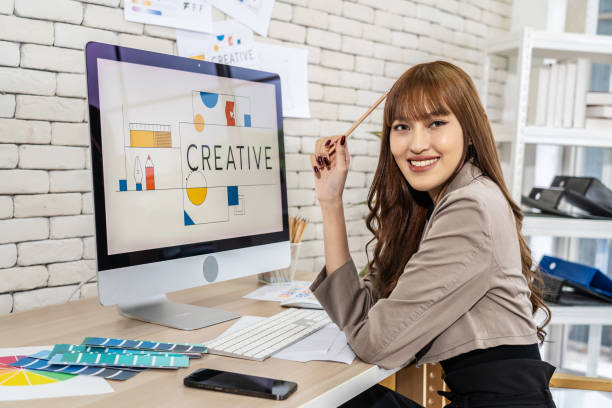 istock Young Asian graphic designer woman working in a creative dynamic office 1927317180