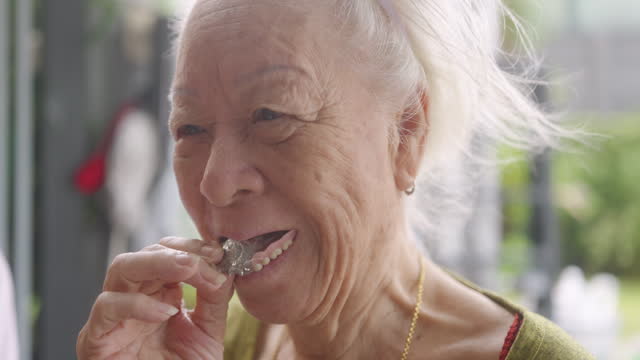 Happy Senior woman wearing dentures.