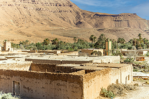 Aoufous, Morocco - Traditional muddy houses by palm oasis around river Ziz