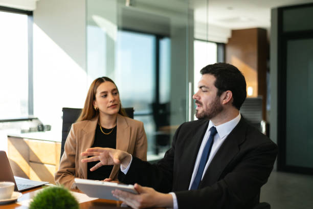 istock Businesspeople sharing some ideas in a meeting room 1927342155