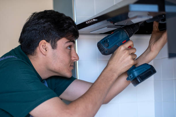 istock Young handyman  doing repairs with a drill at home 1927383897