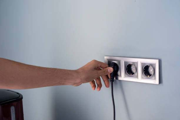 Industrial red electrical connector with thick black wiring representing reliable energy connection, safety, and functionality in professional workshop or construction settings
