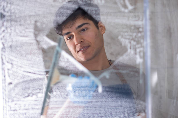 istock Young man cleaning the bathroom 1927384943