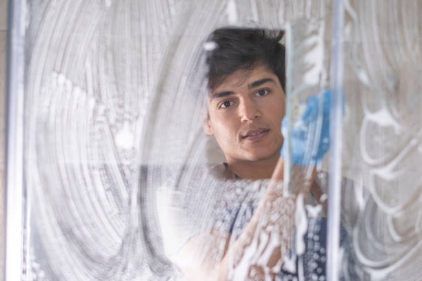 Young man cleaning the bathroom