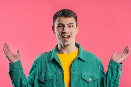 Shocked man glad, he screaming WOW. Impressed guy trying to get attention. Concept of summer sale, profitable offer. Excited happy on pink background. High quality