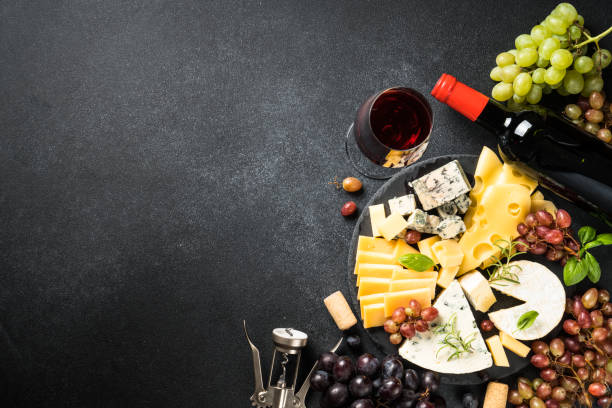 istock Cheese platter and red wine on black background. 1927481574