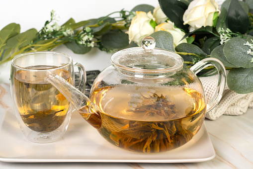 Blooming flower tea in a glass cup
