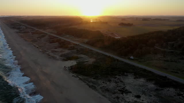 Scenic Shot Tilt Up Sunset Waves Beach Punta del Este Uruguay, Coastline Campaign Haze Road
