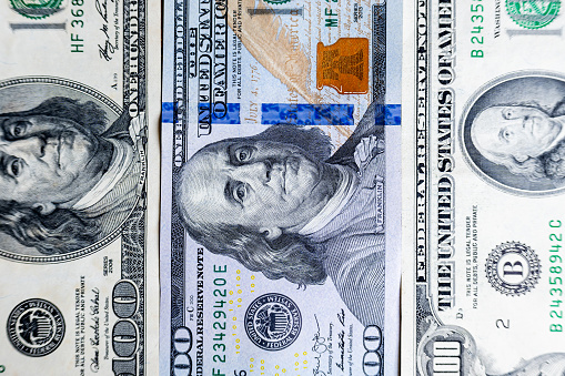 Three different types of hundred dollar bills.