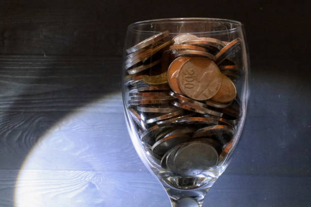 collection of coins in a glass