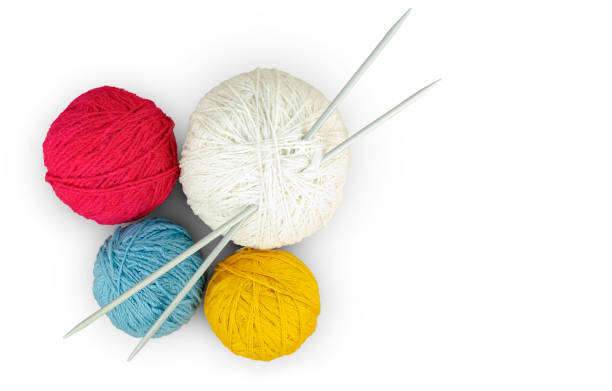 istock Four balls of multi-colored yarn and knitting needles. 1927549610
