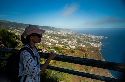 Summer vacations. Female tourist exploring tropical Madeira and having fun enjoying the breathtaking view of nature. Cabo Girao Viewpoint