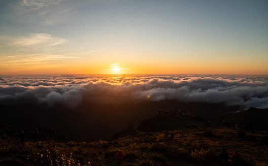High angle view orange sky with setting sun. Mountains of Madeira in Portugal. Pico do Arieiro