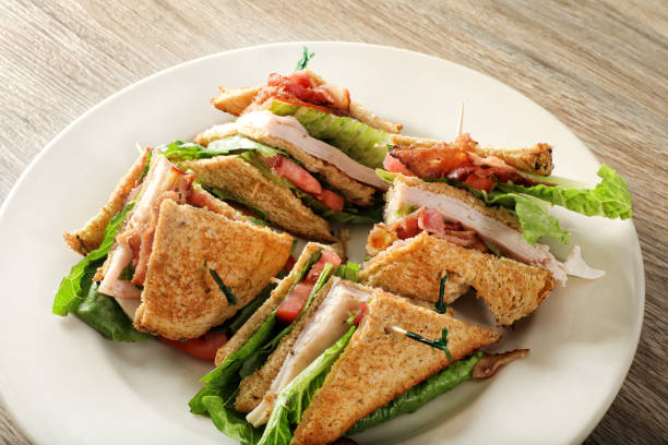 Bacon lettuce tomato and turkey sandwich on plate