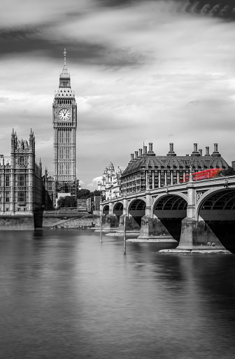 Westminster bridge with Big Ben and the Thames river, in London, UK. Black and white with red selective color