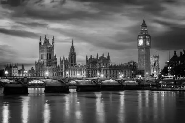 Photo of View of Westminster palace and bridge over river Thames with Big Ben illuminated at night in London, UK
