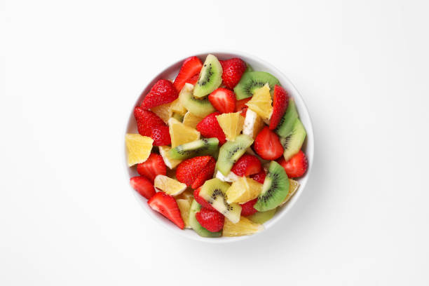 istock Yummy fruit salad in bowl on white background, top view 1927611902
