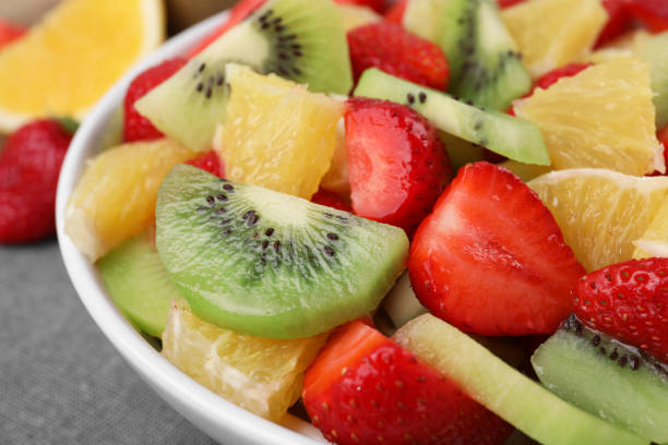 istock Delicious fresh fruit salad in bowl on table, closeup 1927612329