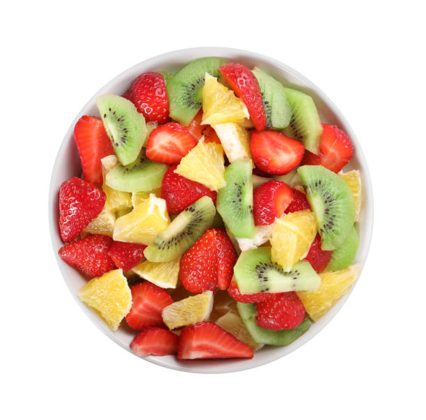 istock Tasty fruit salad in bowl isolated on white, top view 1927616611