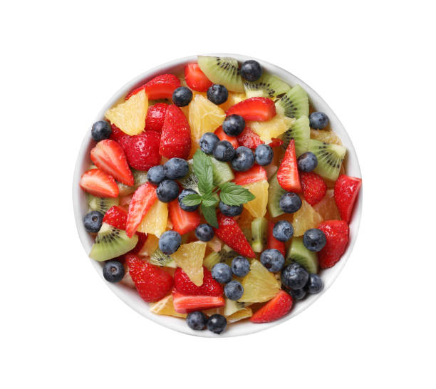 istock Tasty fruit salad in bowl isolated on white, top view 1927616621