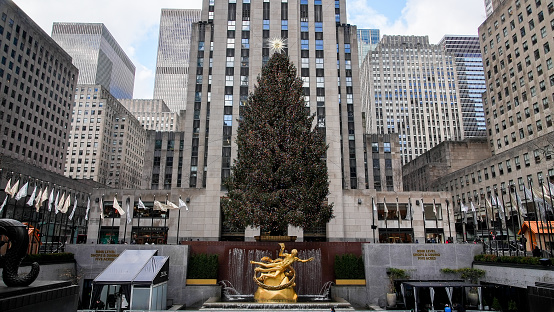 New York, New York, USA - January 10, 2024: Christmas tree at Rockefeller Center with buildings around