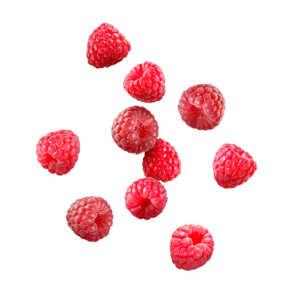 istock Many fresh ripe raspberries falling on white background 1927628346
