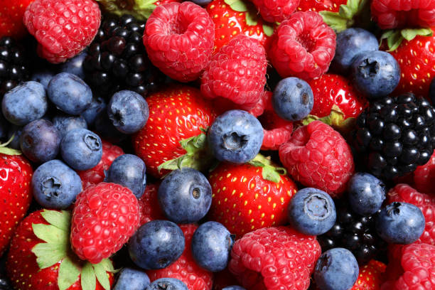 istock Assortment of fresh ripe berries as background, top view 1927629421