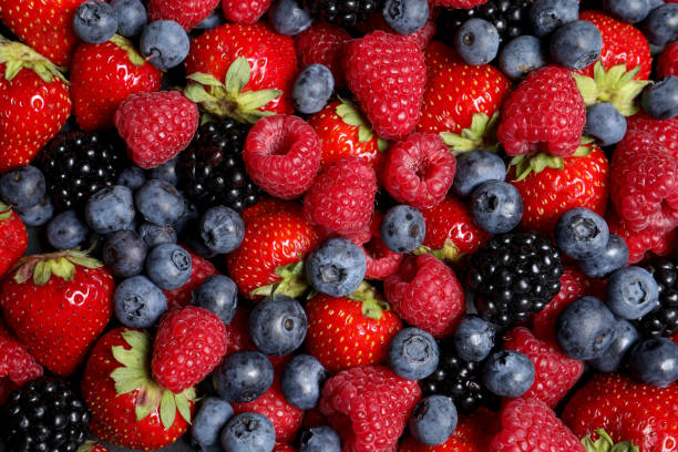 istock Assortment of fresh ripe berries as background, top view 1927631002