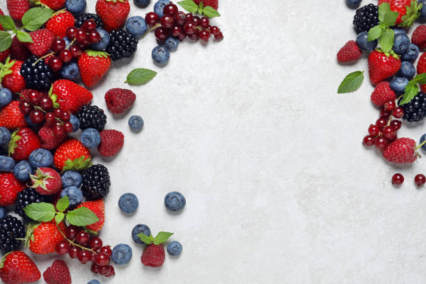 istock Many different fresh ripe berries on white textured table, flat lay. Space for text 1927631016