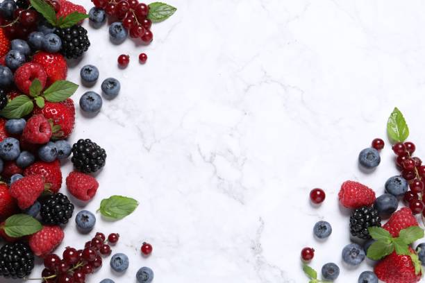istock Many different fresh ripe berries on white marble table, flat lay. Space for text 1927631028