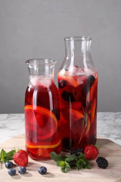 istock Delicious refreshing sangria and berries on white marble table 1927635294