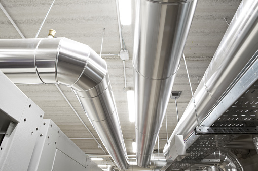 HVAC system pipes, handling heating, ventilation, air conditioning, and cooling, are located on the ceiling. This climate control system ensures the comfort of the rooms in the building.