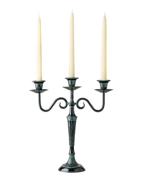 istock Vintage bronze black candlestick with three candles isolated on a white background 1927635821