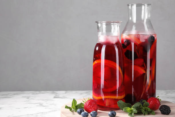 istock Delicious refreshing sangria and berries on white marble table, space for text 1927636390