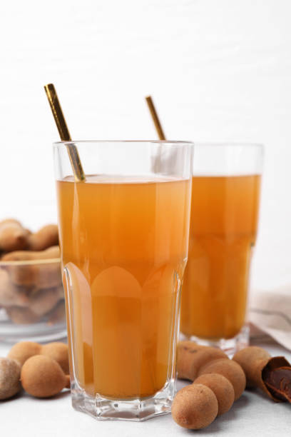 istock Tamarind juice and fresh fruits on white table 1927639101