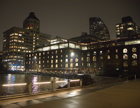 Dumbo, Brooklyn, NY. December 7, 2022. Waterfront view of Dumbo Brooklyn, NY taken on a December night. Old, historic warehouse building that has been revitalized to house new commerce.