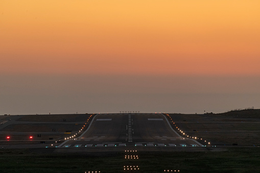 Airport runway at sunset.
