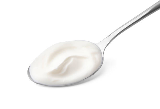 istock Spoon with delicious sour cream isolated on white 1927683667