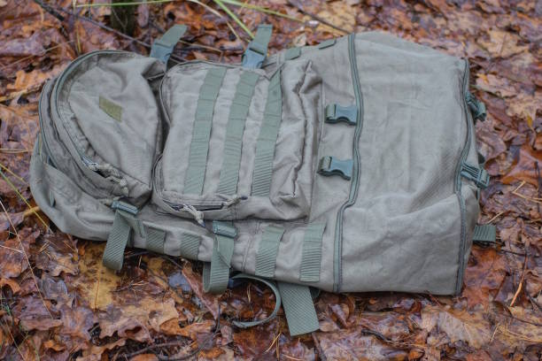 istock one large empty green army backpack lies on the ground 1927692668