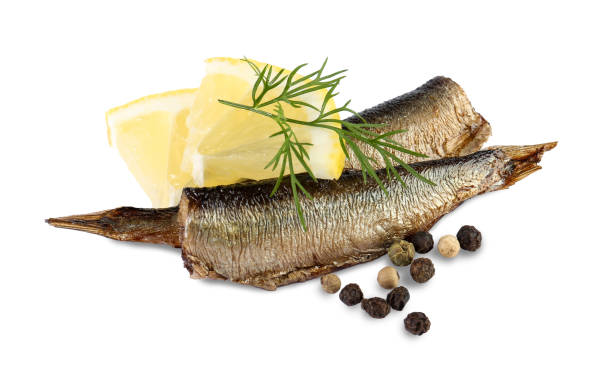 istock Tasty canned sprats, lemon, peppercorns and dill isolated on white 1927703308