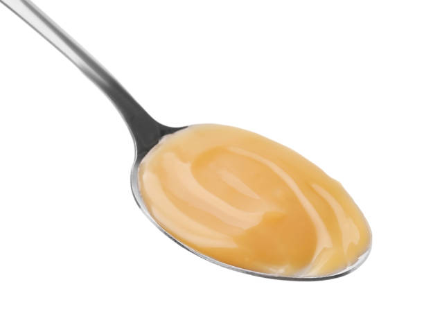 istock Spoon with tasty salted caramel isolated on white 1927712295