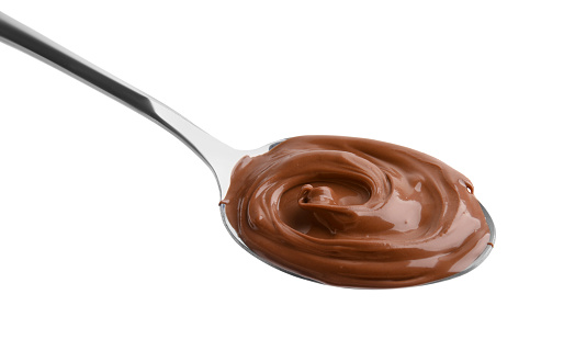 Spoon with delicious chocolate paste isolated on white