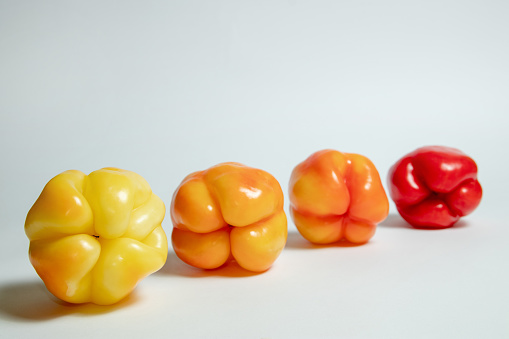 Four yellow orange and red bell peppers