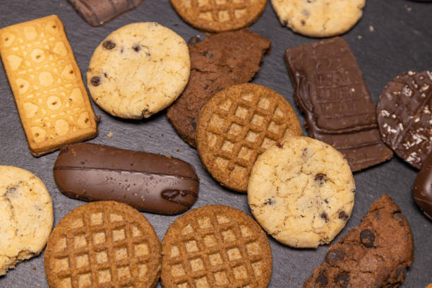 istock Vanilla, chocolate biscuits and biscuits with glaze and chocolate pieces on a black stone slab 1927722323