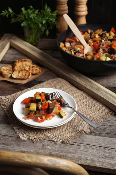 istock Delicious ratatouille served with bread on wooden table 1927727660