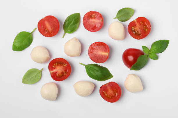 istock Mozzarella, tomatoes and basil on white background, flat lay. Caprese salad ingredients 1927728730