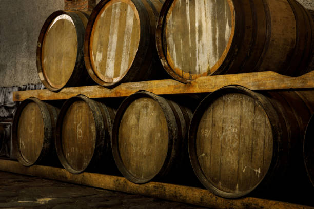 rustic wooden barrels in the cellar. - warehouse floor brewery winery foto e immagini stock