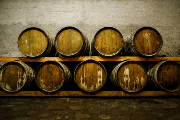 rustic wooden barrels in the cellar. - warehouse floor brewery winery fotografías e imágenes de stock